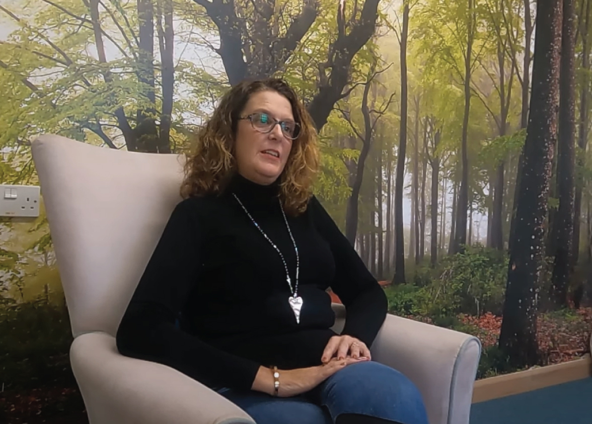 Woman talking at the Tapping House hospice charity to illustrate our Guardians