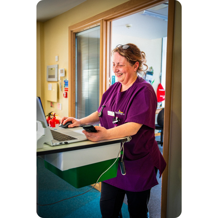 Tapping House Norfolk Hospice team member using laptop