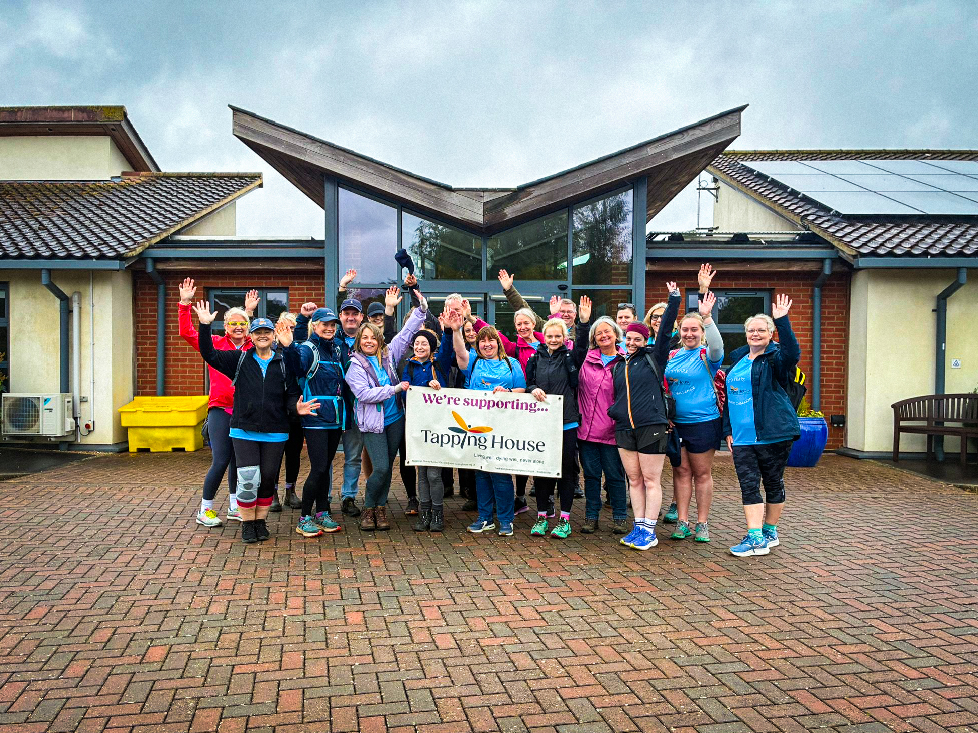 Fundraisers outside Tapping House Norfolk Hospice Charity showing support