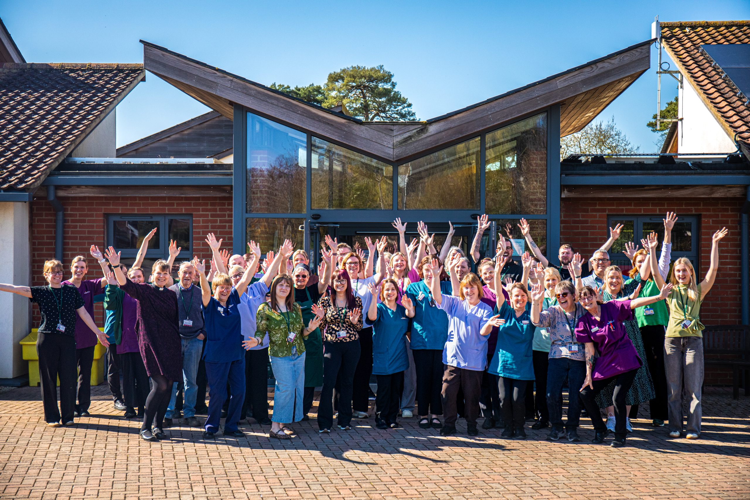 Tapping House Norfolk Hospice Charity Team outside of the building